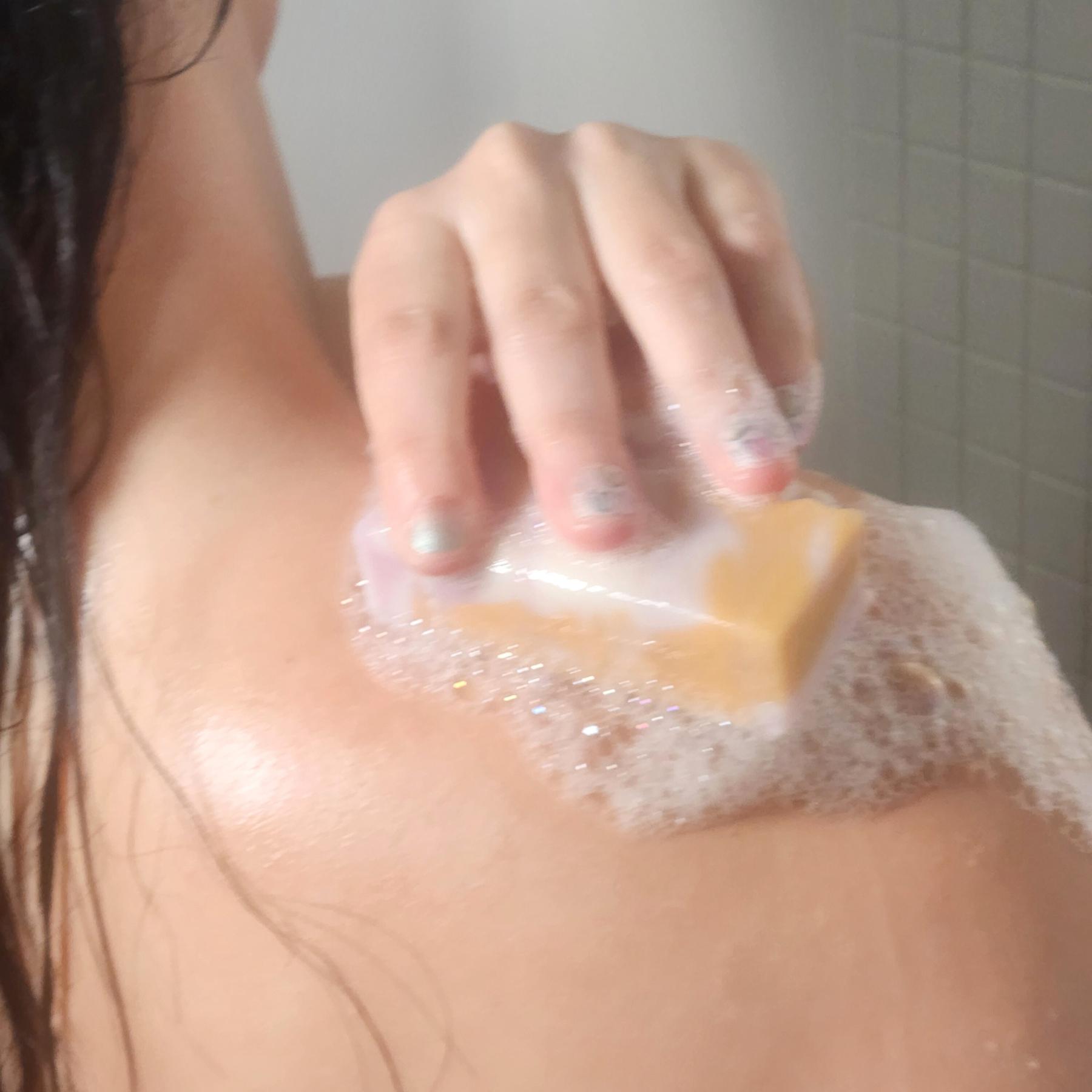 Person using Apple Cider Vinegar and Yogurt Mild Shea Butter Soap to cleanse shoulder with rich foam